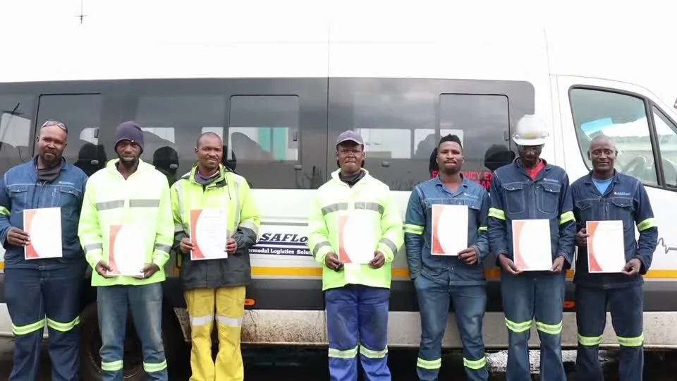 SAFLog employees displaying their training certificates
