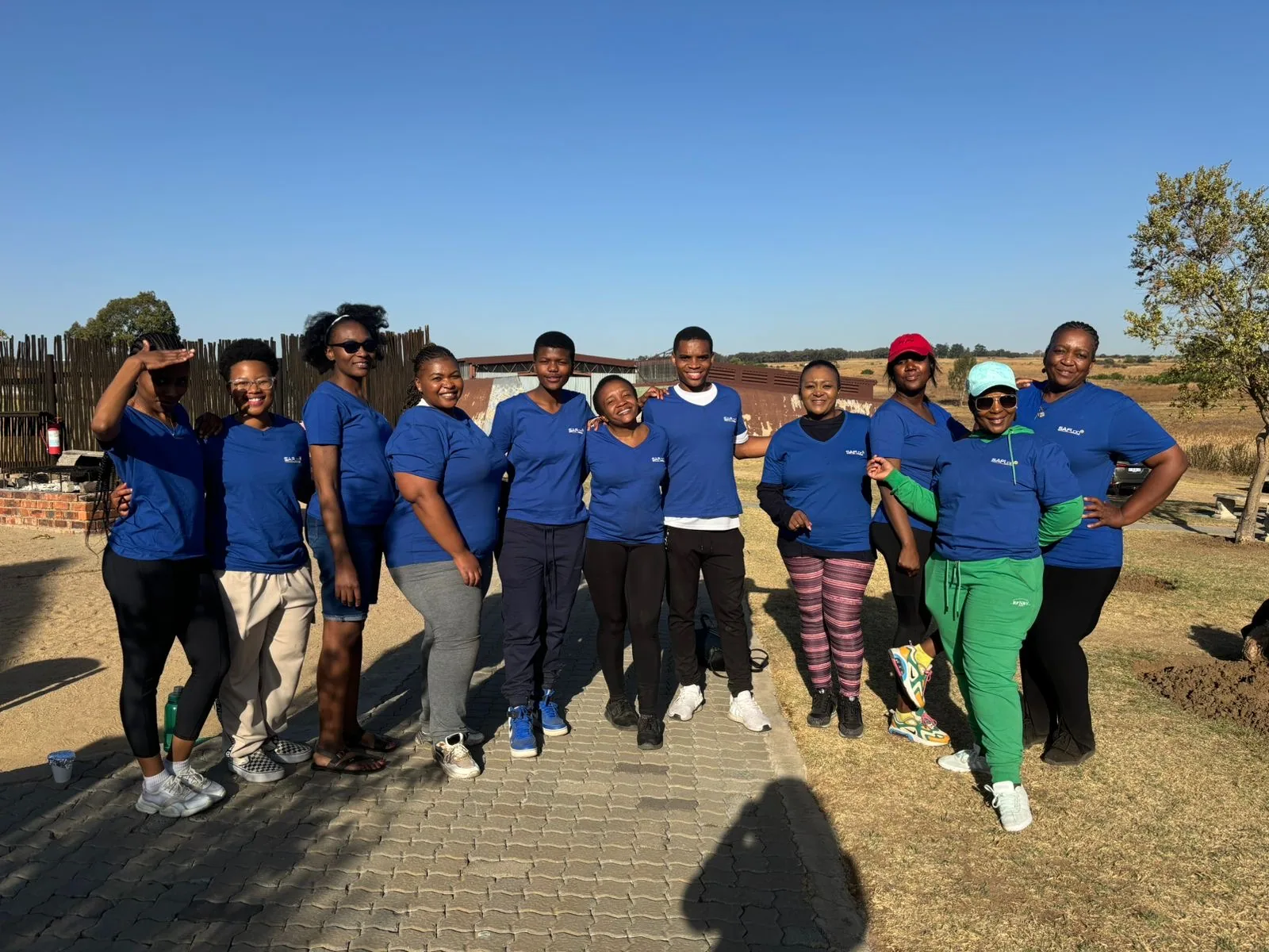 A group of colleagues posing together outdoors.